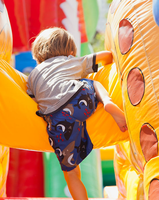 Boy Playing in Bouncy Castle